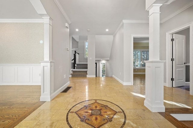 entrance foyer with ornamental molding and ornate columns