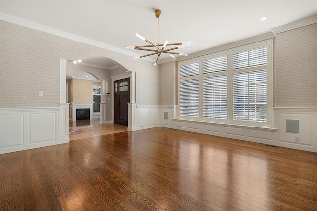 unfurnished room with ornamental molding, a wealth of natural light, and hardwood / wood-style floors