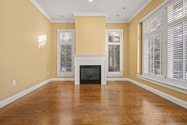 unfurnished living room featuring hardwood / wood-style flooring and crown molding