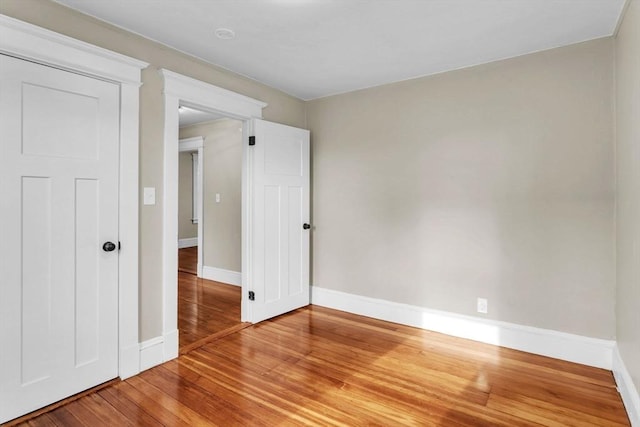 unfurnished room with wood-type flooring