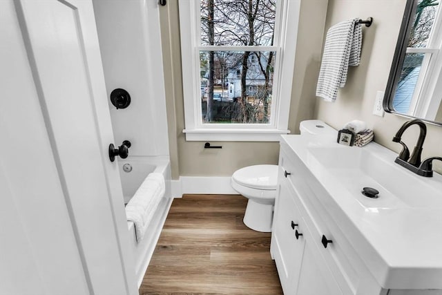 full bathroom featuring shower / bathing tub combination, vanity, wood-type flooring, and toilet