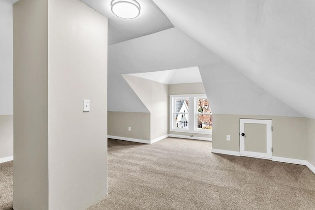 bonus room with carpet flooring and vaulted ceiling