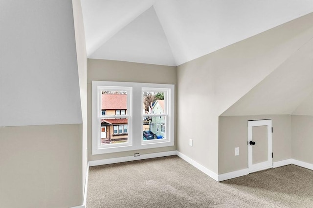 bonus room featuring light carpet and lofted ceiling