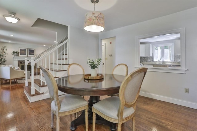 1 Columbine Rd, Milton, MA 02186 - dining space with wood finished floors, stairway, baseboards, a fireplace, and recessed lighting
