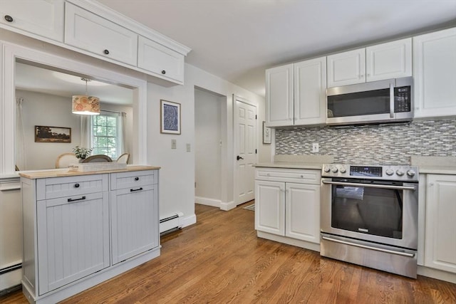 1 Columbine Rd, Milton, MA 02186 - kitchen with appliances with stainless steel finishes, white cabinets, light wood finished floors, and light countertops