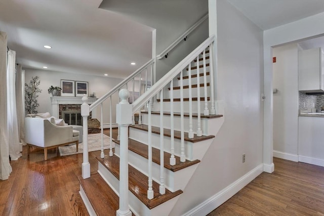 1 Columbine Rd, Milton, MA 02186 - staircase with wood finished floors, baseboards, a glass covered fireplace, baseboard heating, and recessed lighting