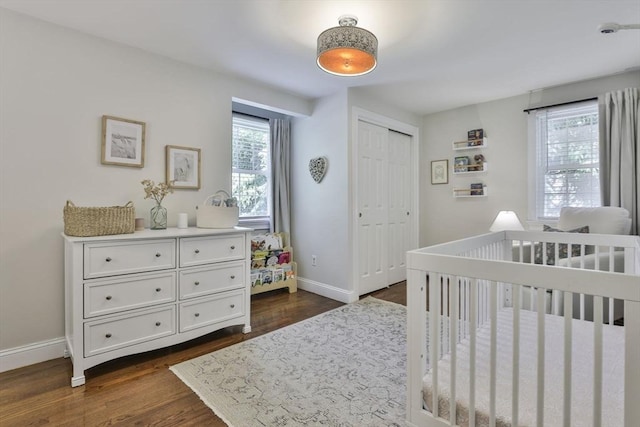 1 Columbine Rd, Milton, MA 02186 - bedroom featuring dark wood-type flooring, baseboards, a closet, and a nursery area