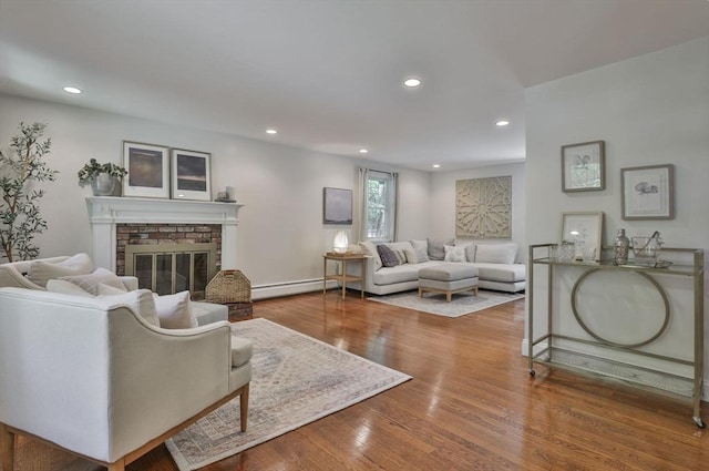 1 Columbine Rd, Milton, MA 02186 - living area with a brick fireplace, recessed lighting, wood finished floors, and baseboard heating