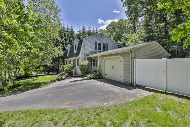 1 Columbine Rd, Milton, MA 02186 - view of front of home with an attached garage, driveway, a gambrel roof, and a shingled roof