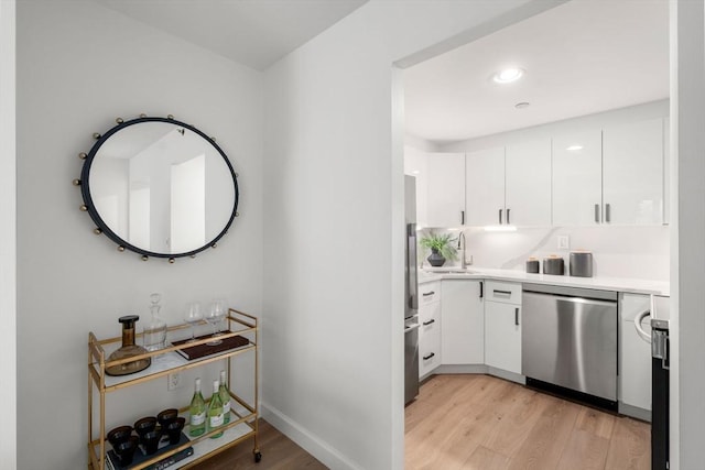 10 Rogers Unit 1119, Cambridge, MA 02142 - kitchen with stainless steel appliances, light wood finished floors, white cabinets, light countertops, and recessed lighting
