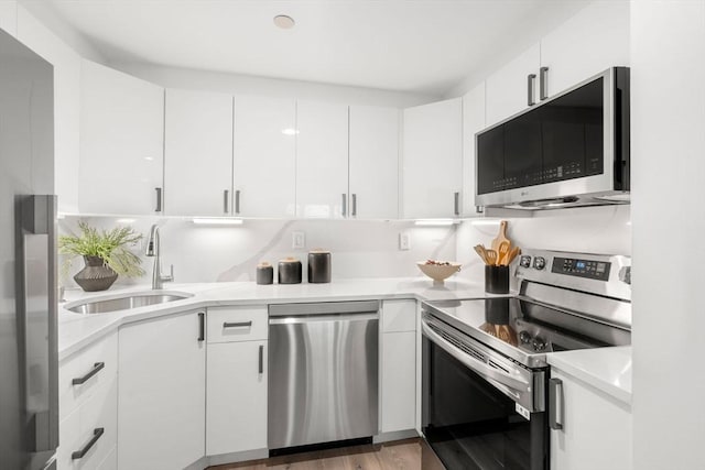 10 Rogers Unit 1119, Cambridge, MA 02142 - kitchen featuring stainless steel appliances, white cabinetry, light countertops, and wood finished floors