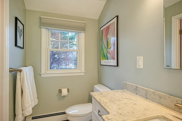 bathroom featuring toilet, a baseboard heating unit, and vanity