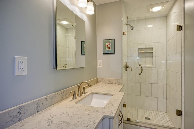 full bathroom with a stall shower and vanity