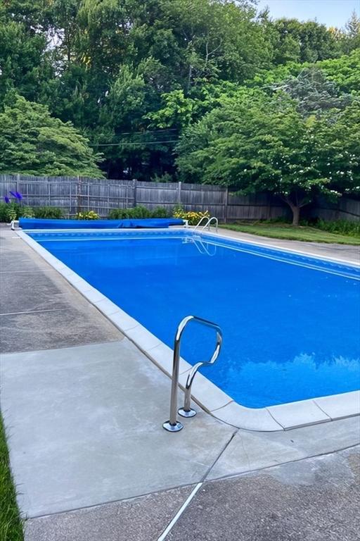 view of swimming pool with a fenced in pool and fence