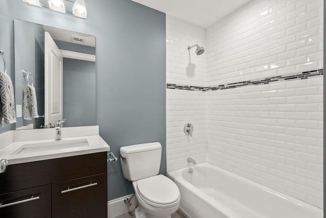 bathroom featuring washtub / shower combination, toilet, vanity, and baseboards
