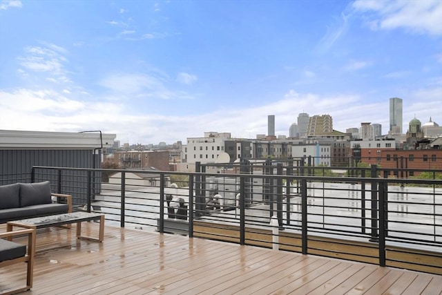 wooden terrace with a skyline view and an outdoor hangout area