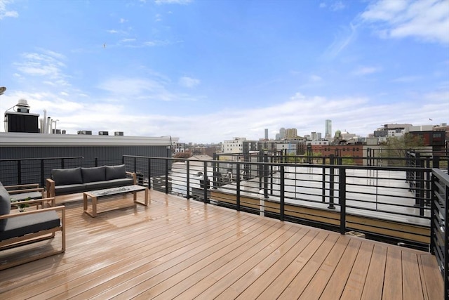 wooden terrace featuring an outdoor hangout area and a view of city