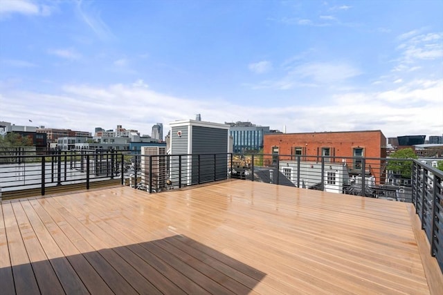 wooden terrace featuring a city view