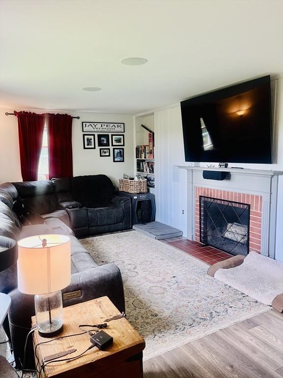 35 Marsh Ave, Worcester, MA 01605 - living area with wood finished floors and a brick fireplace