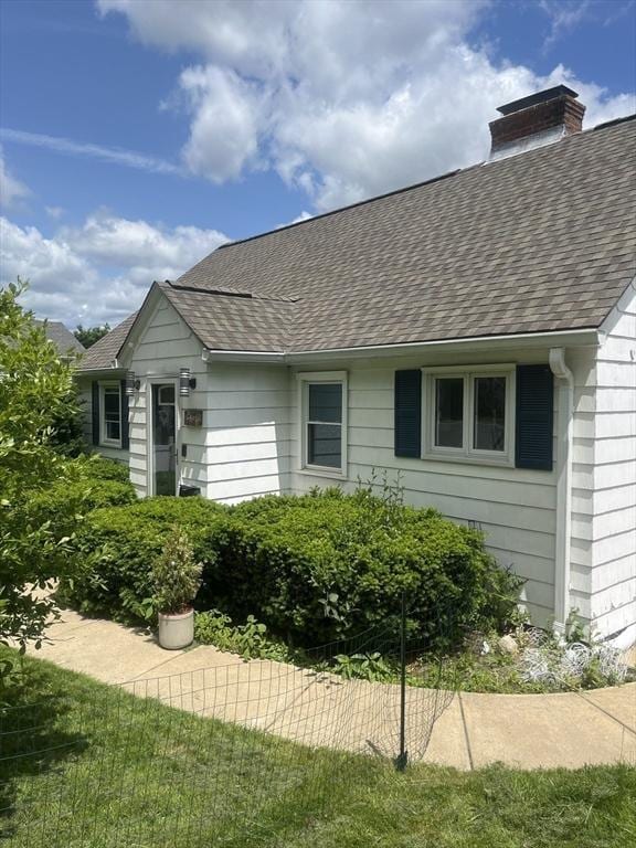 35 Marsh Ave, Worcester, MA 01605 - back of house with a chimney and roof with shingles
