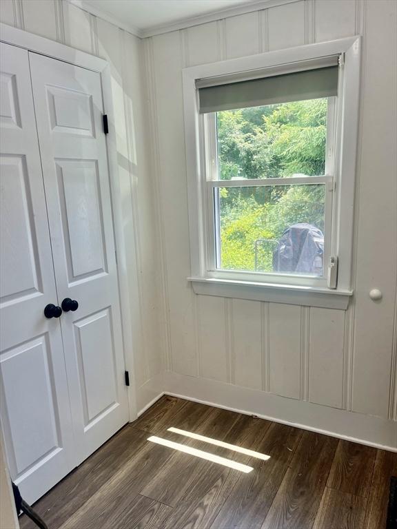 35 Marsh Ave, Worcester, MA 01605 - unfurnished room featuring dark wood-style flooring, a decorative wall, and ornamental molding