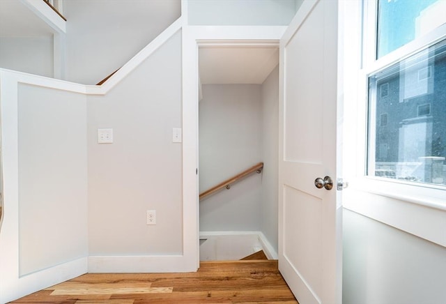 stairway with baseboards and wood finished floors