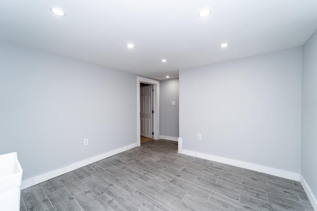 spare room featuring baseboards, light wood-type flooring, and recessed lighting