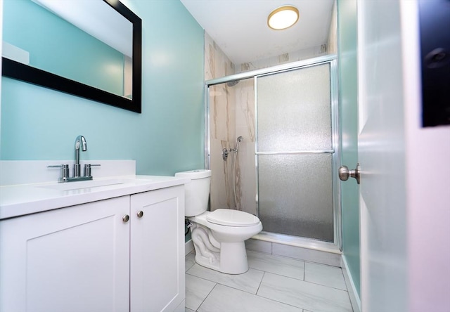 full bathroom with toilet, a stall shower, and vanity