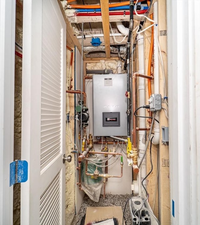 utility room featuring water heater