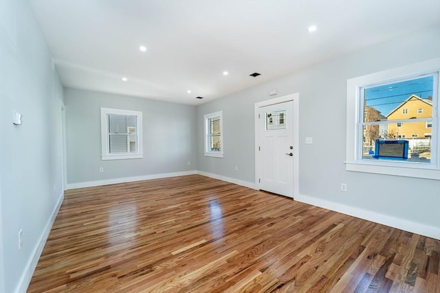 entrance foyer featuring baseboards, wood finished floors, and recessed lighting