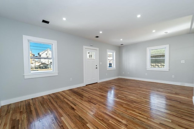 interior space featuring recessed lighting, baseboards, and wood finished floors