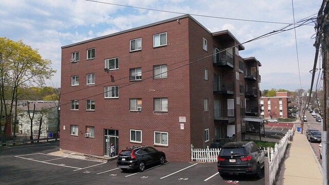175 Clare Ave Unit B2, Boston, MA 02136 - view of building exterior featuring fence and uncovered parking