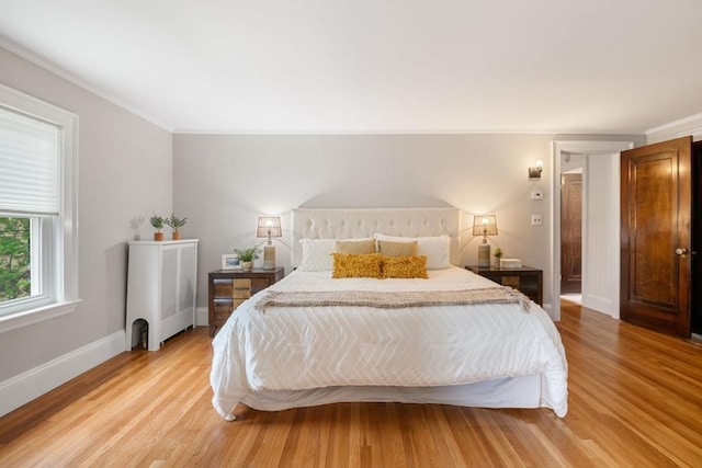 bedroom featuring radiator, light wood-type flooring, and ornamental molding