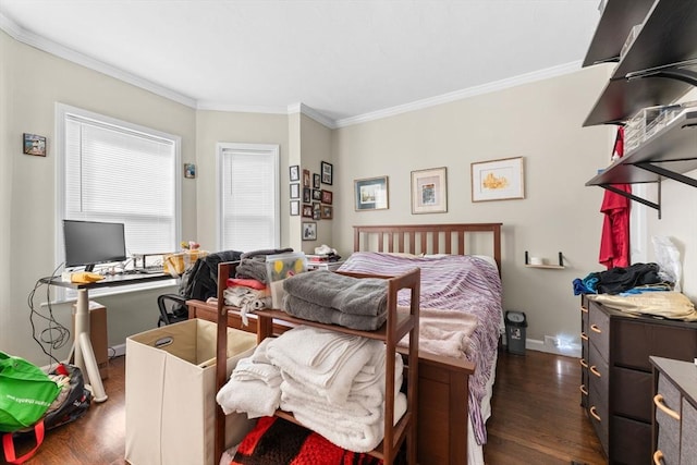 bedroom with dark wood-type flooring, crown molding, and baseboards
