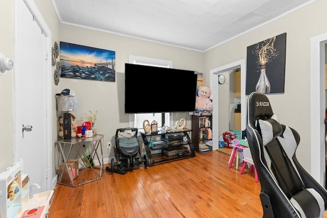 interior space with hardwood / wood-style flooring, baseboards, and ornamental molding