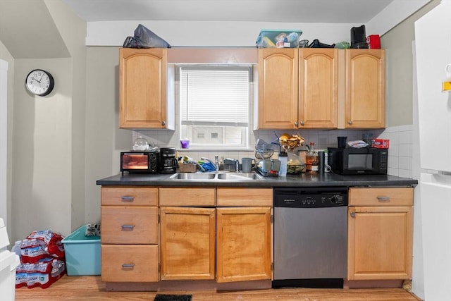 kitchen with black microwave, dishwasher, a sink, and dark countertops