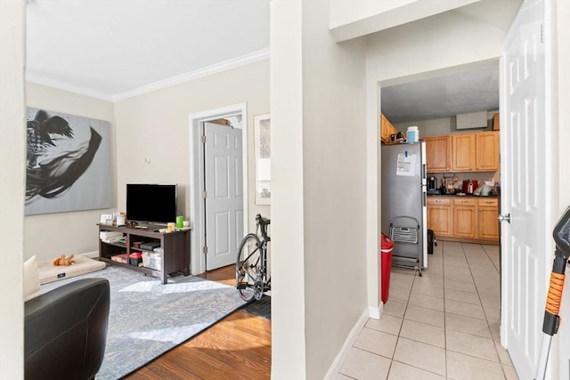 interior space featuring baseboards, ornamental molding, and light tile patterned floors