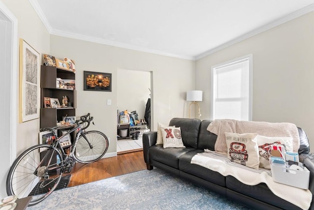 living room with baseboards, ornamental molding, and wood finished floors