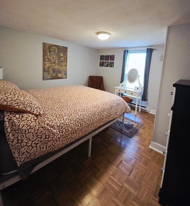 bedroom featuring baseboards and a baseboard radiator