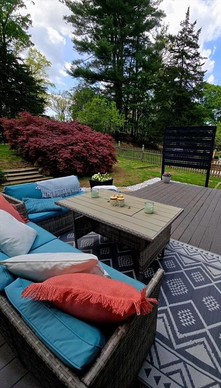 view of pool with outdoor lounge area, a deck, fence, and outdoor dining area