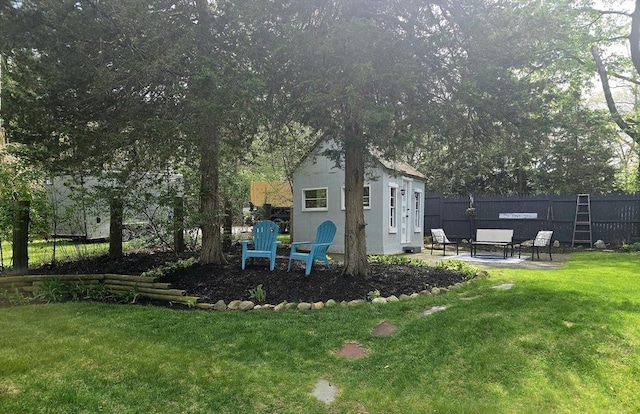 view of yard featuring a patio and an outdoor structure
