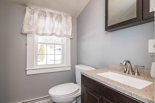 bathroom featuring baseboard heating, vanity, and toilet