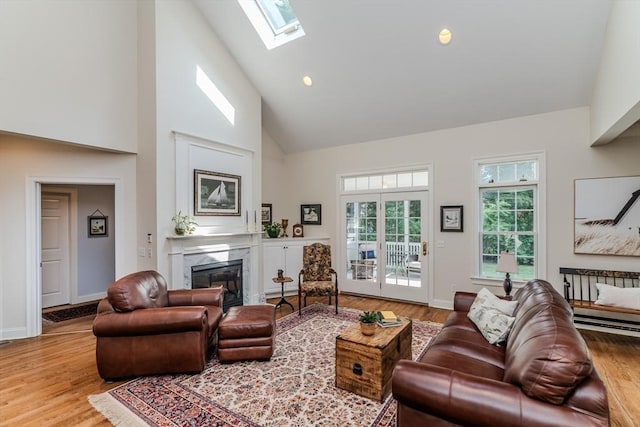 124 High Pine Cir Unit 124, Wilbraham, MA 01095 - living room with high vaulted ceiling, a fireplace, wood finished floors, a skylight, and recessed lighting