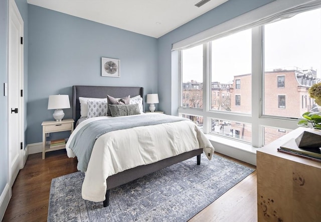 bedroom featuring baseboards and wood finished floors