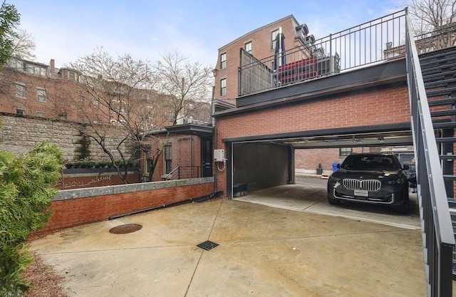 view of side of property featuring brick siding and driveway