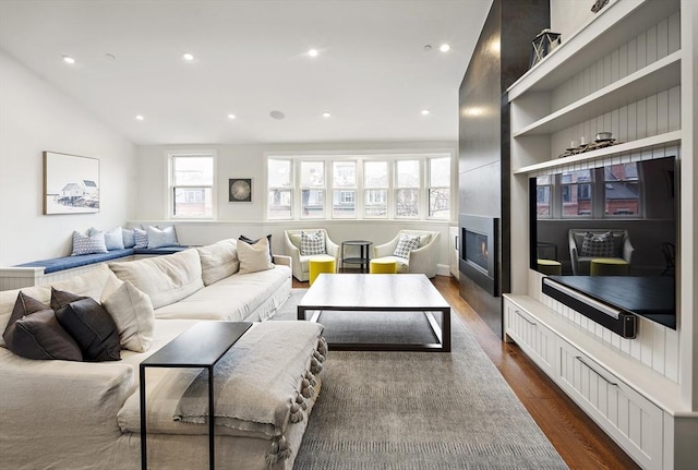 living room with recessed lighting, dark wood finished floors, and a fireplace