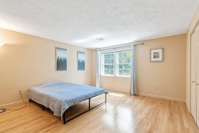 35 Merrymount Rd Unit 12, Quincy, MA 02169 - bedroom with light wood-type flooring, baseboards, and a textured ceiling