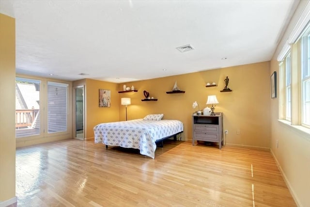 35 Merrymount Rd Unit 12, Quincy, MA 02169 - bedroom featuring multiple windows, access to outside, and light wood-style floors