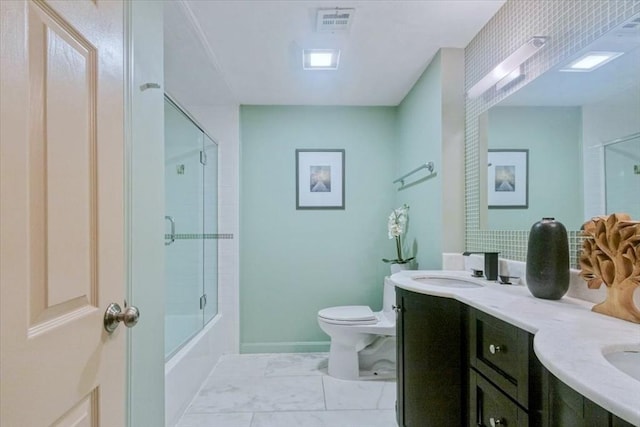 35 Merrymount Rd Unit 12, Quincy, MA 02169 - bathroom featuring double vanity, toilet, combined bath / shower with glass door, and baseboards