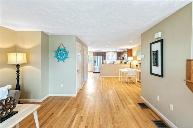 35 Merrymount Rd Unit 12, Quincy, MA 02169 - corridor featuring light wood finished floors, baseboards, and a textured ceiling